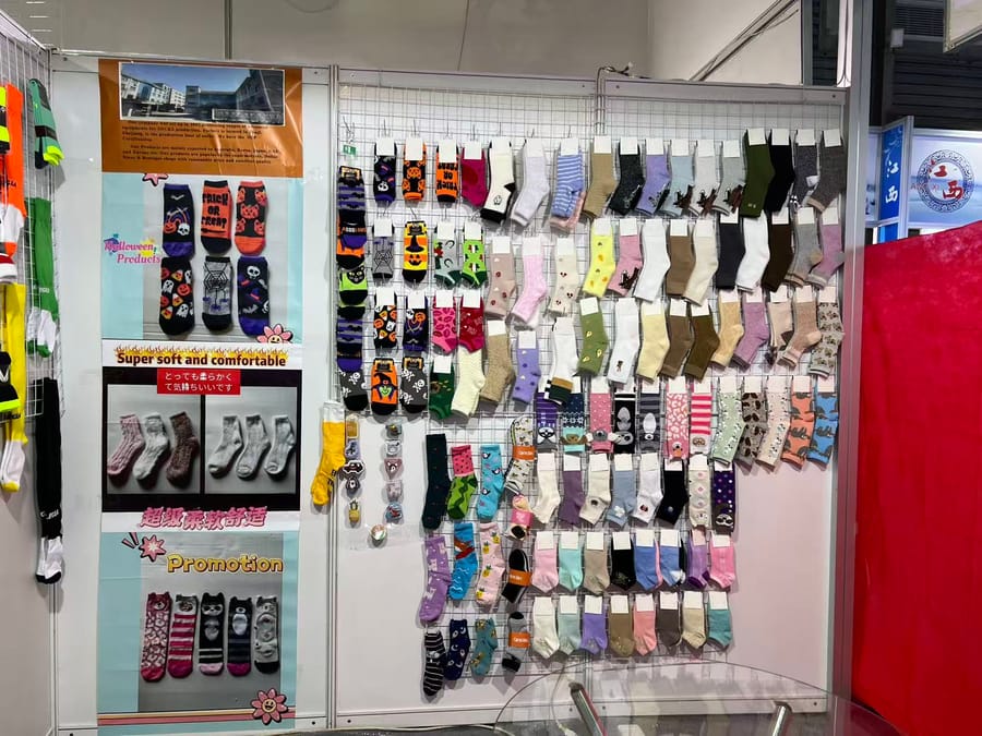 ANV Socks display wall at the East China Fair — women's fashion, novelty, Halloween, kids and cozy socks shown on a full sample grid