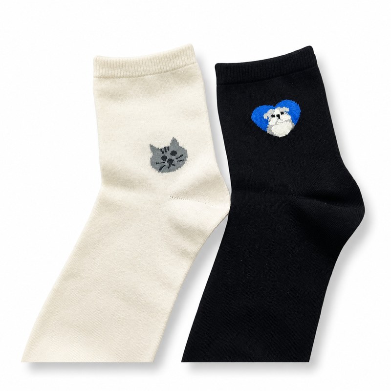 Cat & Dog Novelty Socks by ANV Socks — Cotton blend. Novelty mid-crew socks featuring Jacquard-knit cat and dog motifs — white sock with grey cat face, black sock with blue-heart dog. Popular for pet-themed retail, gift shops, and specialty stores.