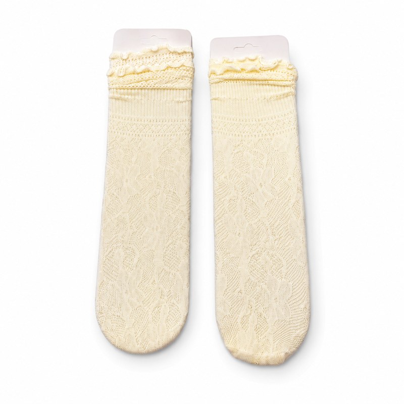Lace Knee-High Socks by ANV Socks — 100% Nylon. Fine-knit lace knee-high socks in cream with ruffle edge cuff. Delicate semi-transparent construction with floral lace pattern. Suitable for bridal accessories, boutique retail, and fashion wholesale.